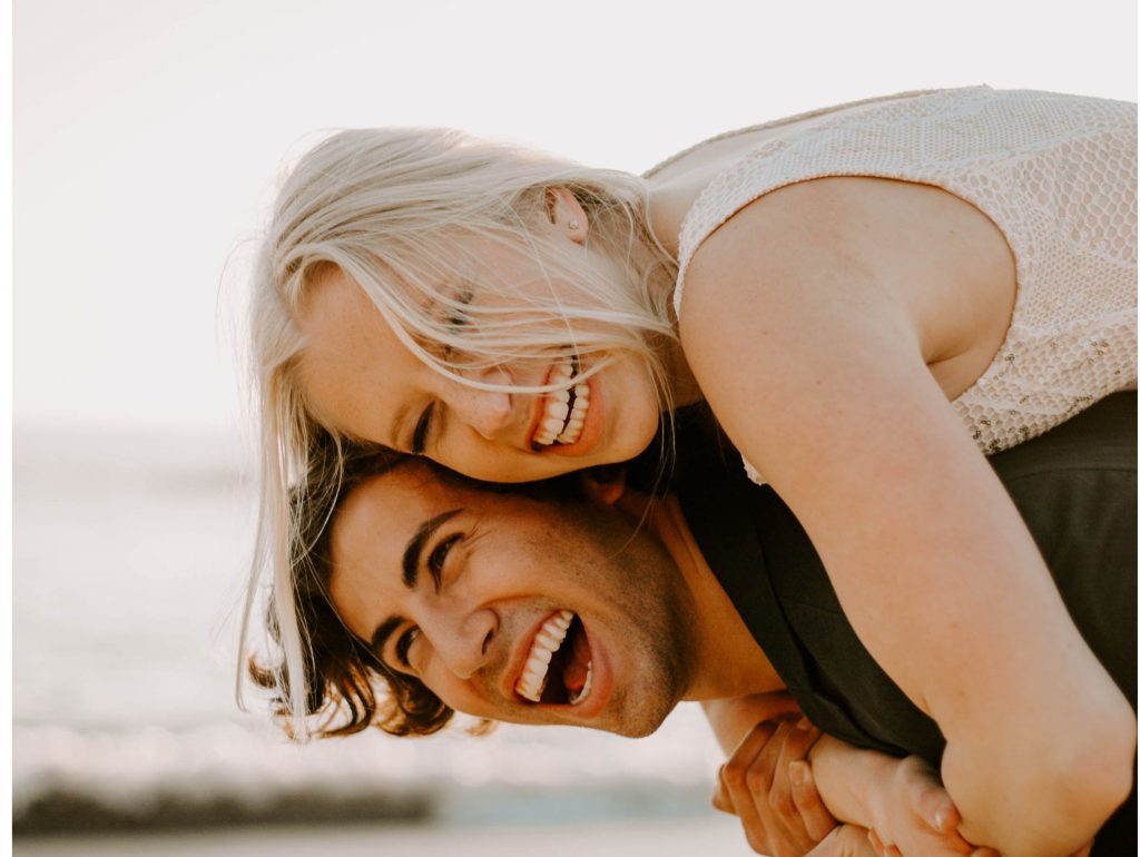 couple laughing on beach